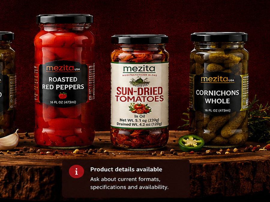 Mezita roasted red peppers, sun-dried tomatoes in oil and cornichons on a rustic wooden slab, with sun-dried tomatoes centered
